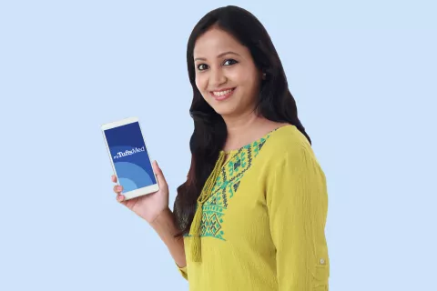 Consumer holding a smartphone showing the screen of the myTuftsMed app.
