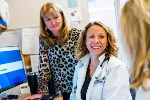 Nurses Michelle Linskey, NM, Cynthia Enright, NP, and Jill Brazel, NP meeting in office in the cardiac arrhythmia center at Tufts Medical Center.