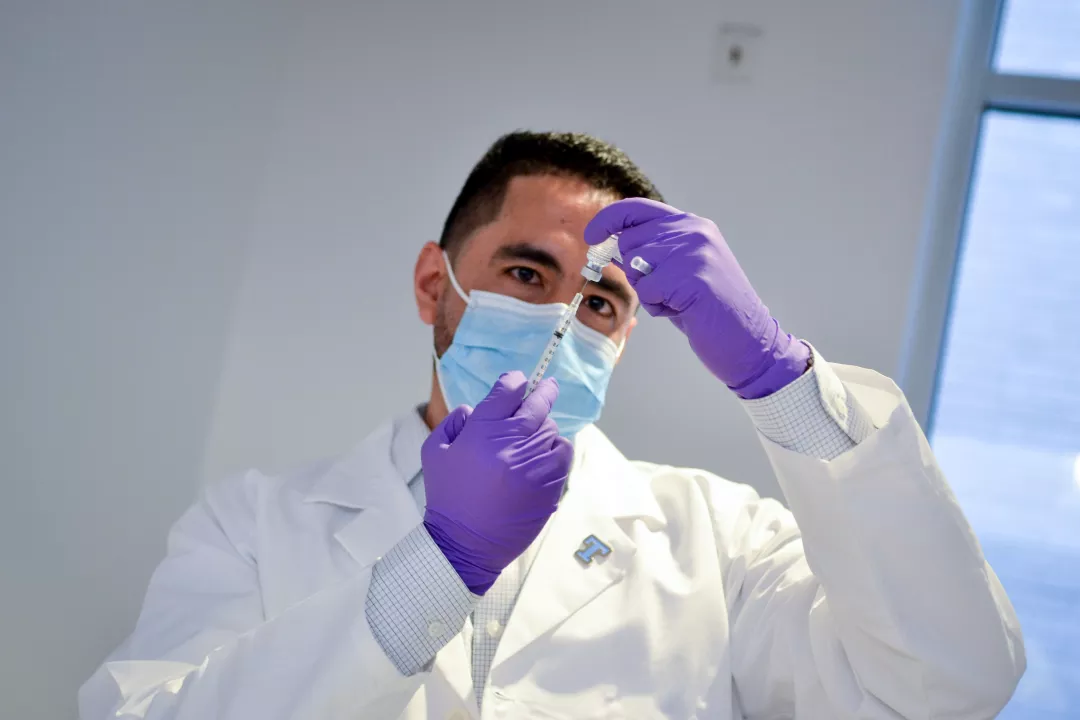 Tufts Medical Center pharmacist preparing COVID-19 vaccine.