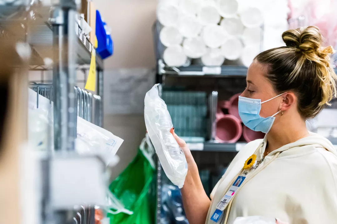 Delaney McCarthy, RN gathering supplies in the Neurology Trauma Unit at Tufts Medical Center.